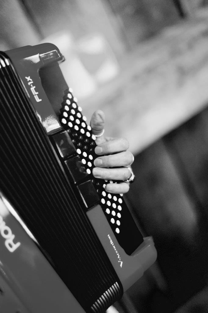 evermore weddings accordion closeup with hand