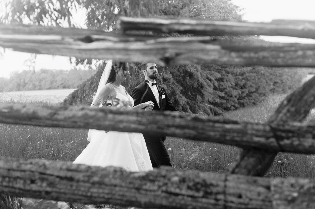 evermore weddings bride groom through fence
